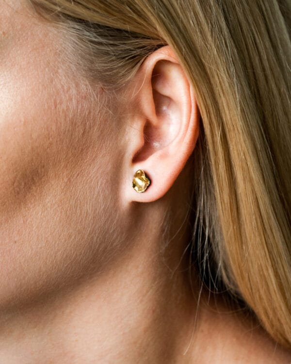 Handmade black porcelain stud earrings with irregular shape and gold luster interior
