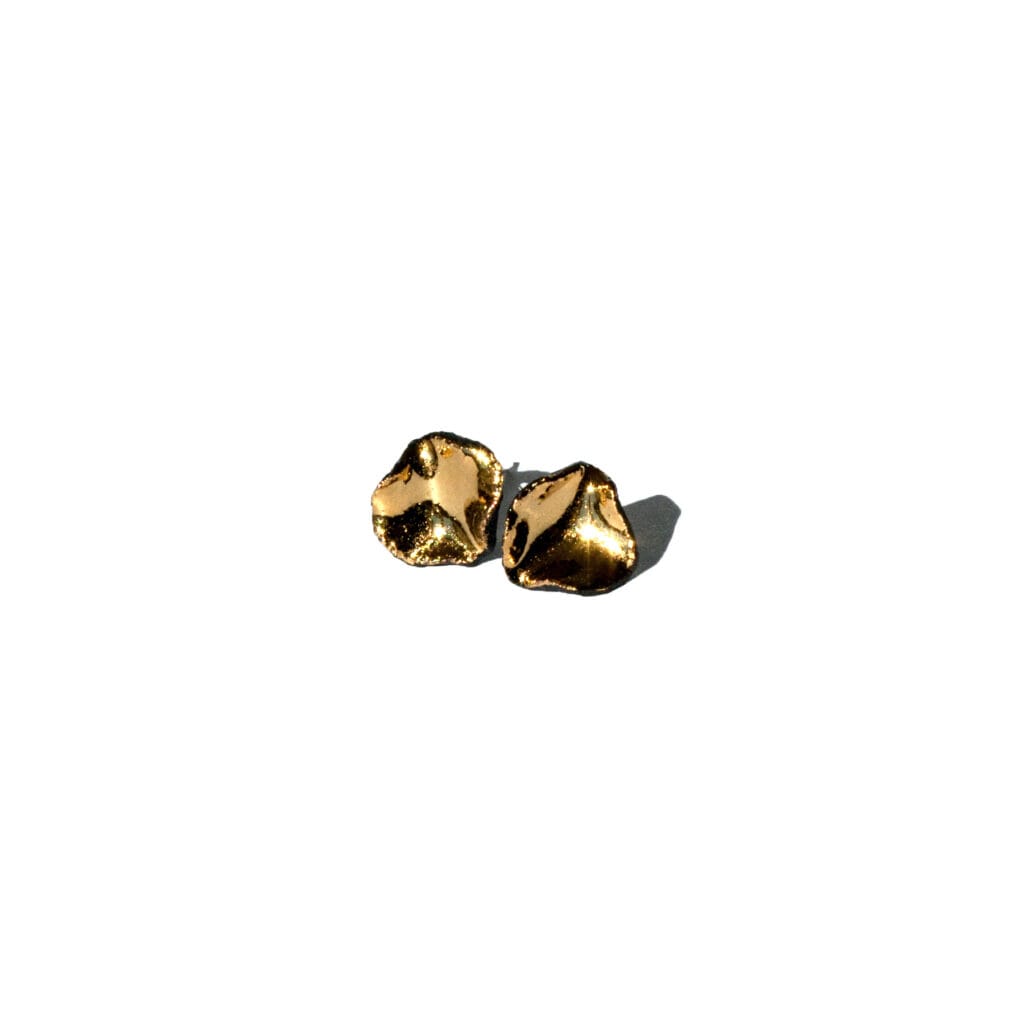 Handmade black porcelain stud earrings with irregular shape and gold luster interior