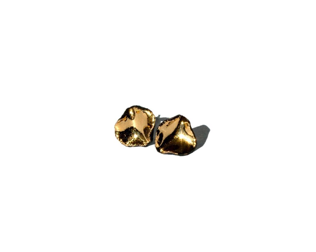 Handmade black porcelain stud earrings with irregular shape and gold luster interior