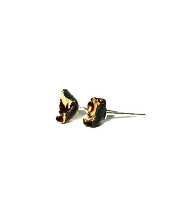 Handmade black porcelain stud earrings with irregular shape and gold luster interior