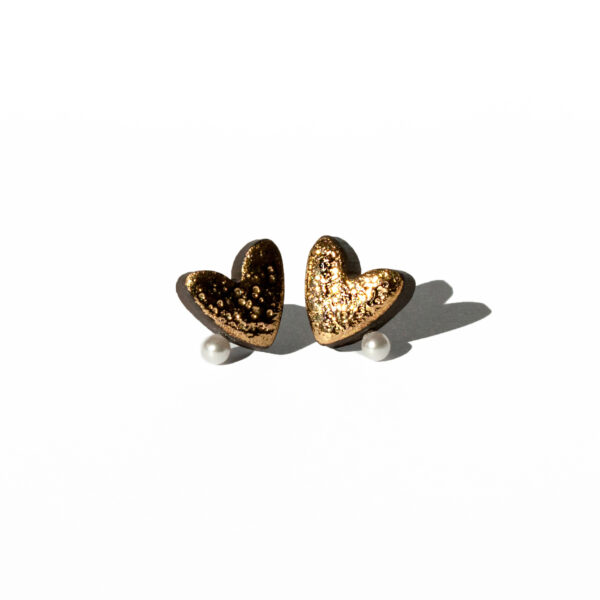 Handmade ceramic heart earrings with moon texture, gold luster, and a pearl detail