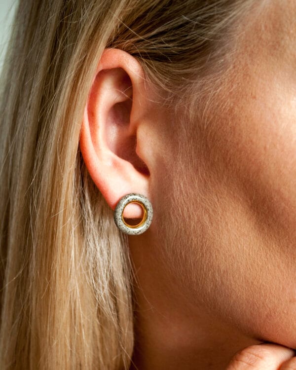 Grey stoneware ring-shaped earrings with clear glossy glaze and gold luster accent