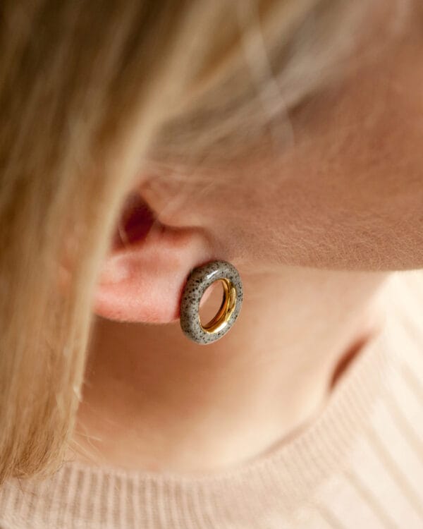 Grey stoneware ring-shaped earrings with clear glossy glaze and gold luster accent