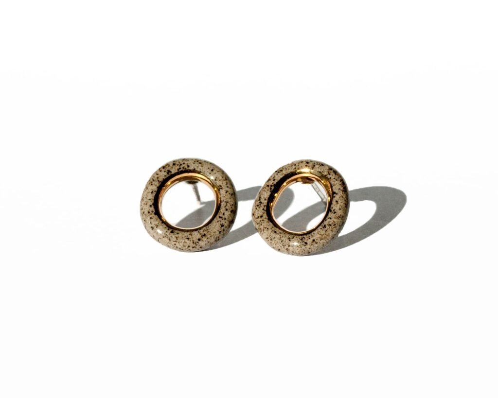 Grey stoneware ring-shaped earrings with clear glossy glaze and gold luster accent