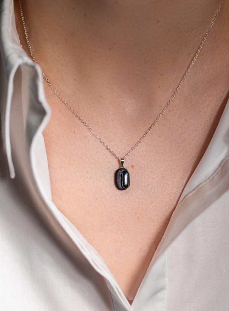 Handmade black porcelain pendant necklace with two-layer design, matte and glossy finishes, platinum luster decoration, and sterling silver chain