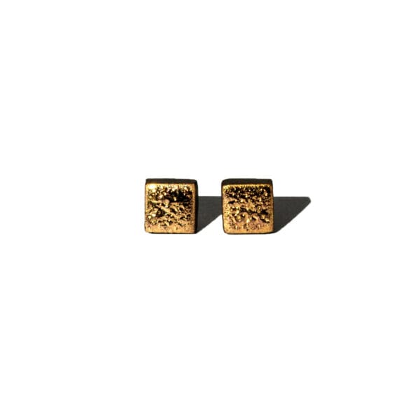 Square handmade ceramic earrings with moon-textured black clay and 24k gold luster accents