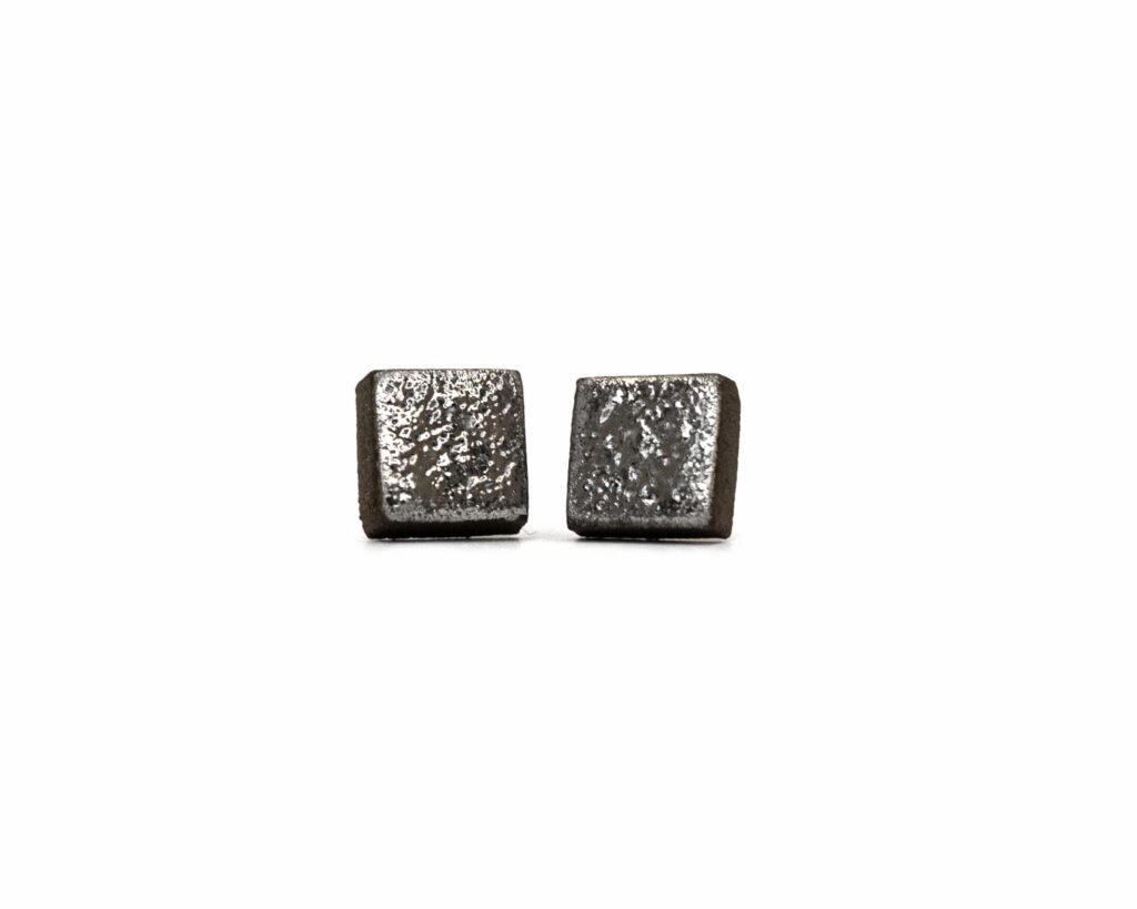 Handmade round ceramic earrings with moon-textured black clay and platinum luster - front view