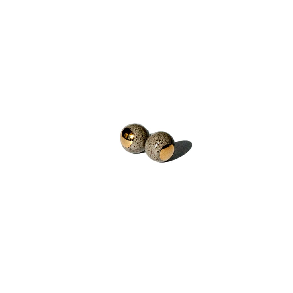 Handmade grey stoneware pearl-shaped stud earrings with clear glossy glaze and hand-painted gold luster dot