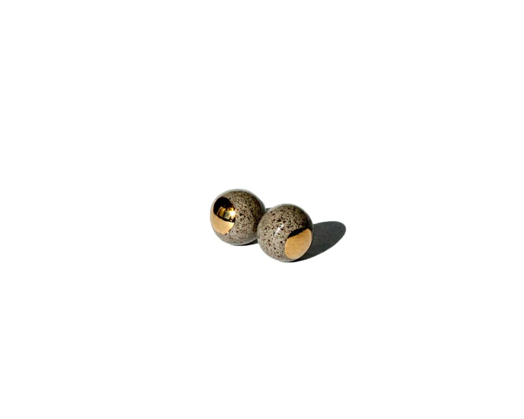 Handmade grey stoneware pearl-shaped stud earrings with clear glossy glaze and hand-painted gold luster dot