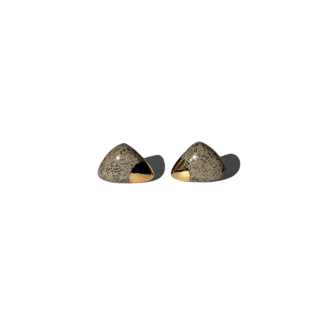 Handmade grey stoneware triangular stud earrings with rounded corners, clear glossy glaze, gold luster accents, and sterling silver posts