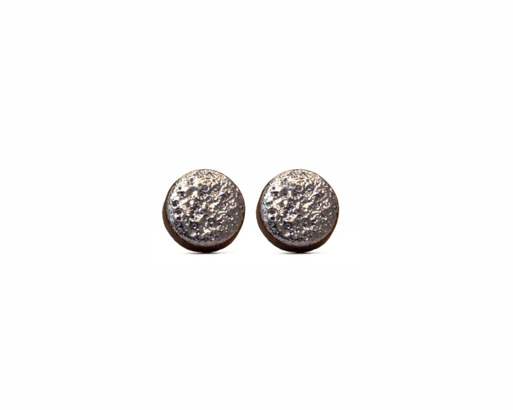 Handmade round ceramic earrings with moon-textured black clay and platinum luster - fron view