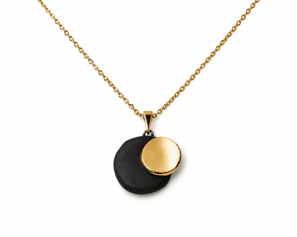 Dual handmade black porcelain pendant necklace with gold luster, layered sculptural design on gold-plated sterling silver chain, by Clayometry