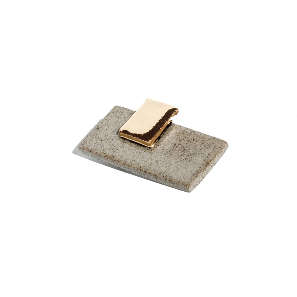 Urban Stillness handmade stoneware brooch with speckled grey base, glossy glaze, small 24k gold luster rectangle, classic pin back, minimalist geometric design