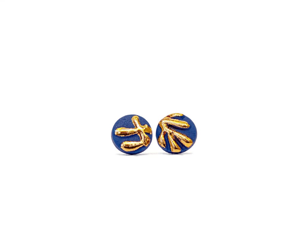 Front view of Handmade Botanical Relief – Gold porcelain stud earrings with raised botanical pattern and gold luster