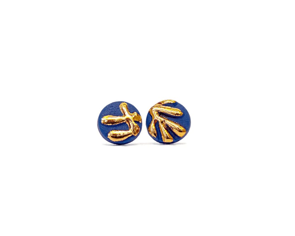 Front view of Handmade Botanical Relief – Gold porcelain stud earrings with raised botanical pattern and gold luster