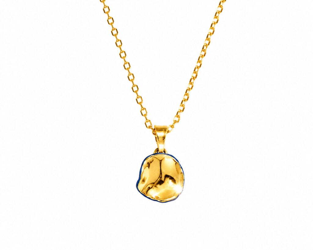 Blue Matter Small ceramic pendant necklace in blue porcelain with gold luster finish, front view