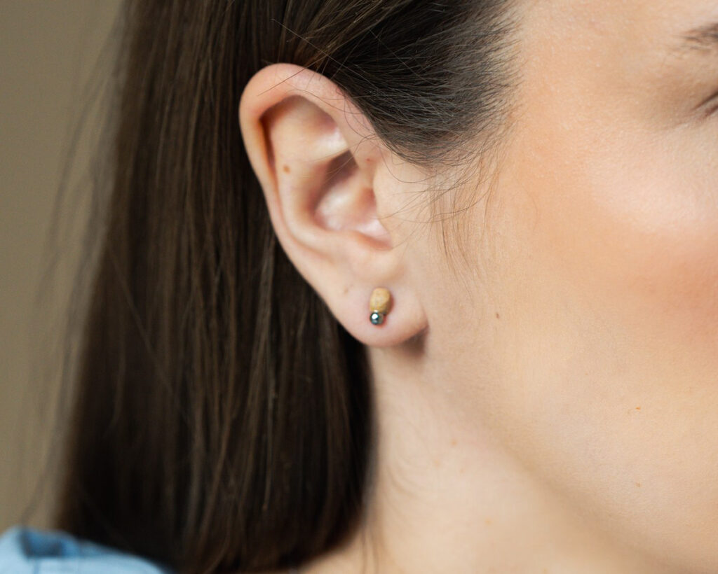 Mini Bud Platinum handmade ceramic stud earrings worn on ear