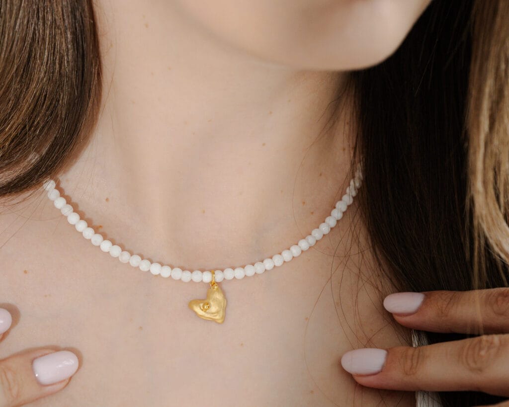 Tender Heart handmade white jade beaded necklace with a matte gold heart pendant, detail view