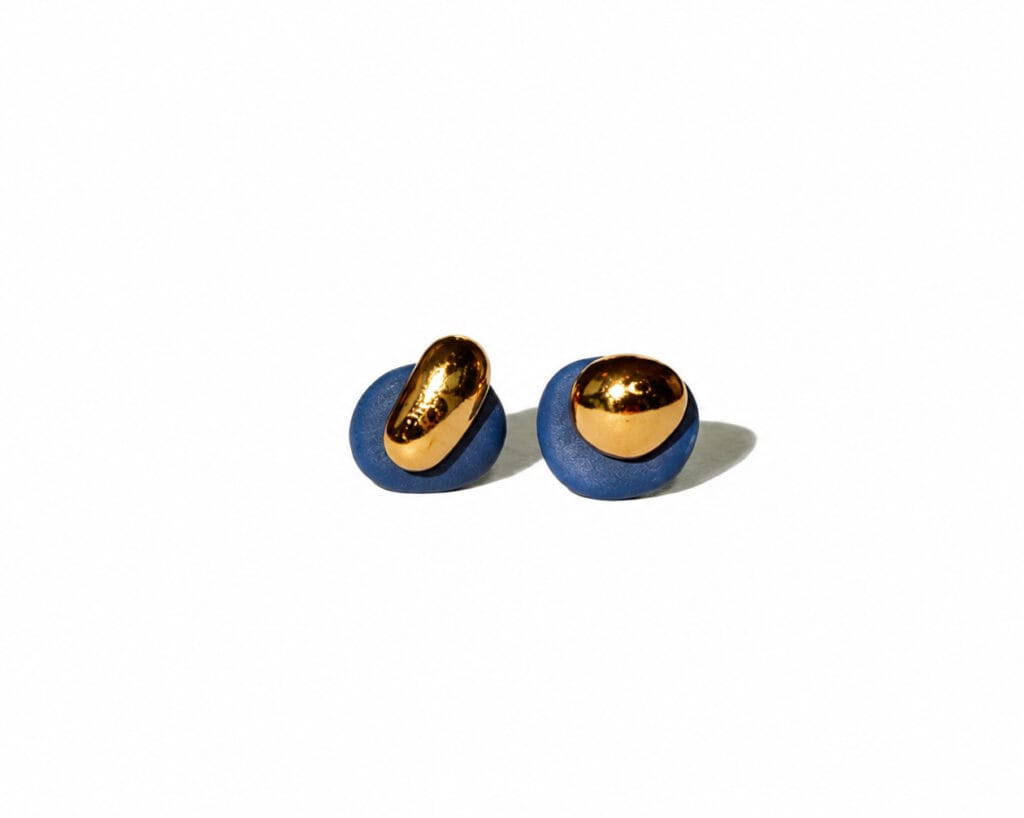 Dual Blue handmade blue porcelain stud earrings with matte texture and 24k gold luster details on a white background